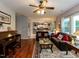 Bright living room with hardwood floors seamlessly connects to an open kitchen at 122 Button Rd, Morrisville, NC 27560