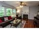 Inviting living room with a fireplace, plush sofa, and hardwood floors at 122 Button Rd, Morrisville, NC 27560