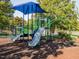 Well-maintained playground with slides and play structures in a secure, shaded area at 122 Button Rd, Morrisville, NC 27560