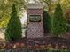 Brick sign at Breckenridge Swim & Tennis Club, surrounded by flowers, trees and landscaping at 122 Button Rd, Morrisville, NC 27560