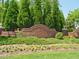 Landscaped community sign for Breckenridge with brick wall and flower beds in a residential area at 122 Button Rd, Morrisville, NC 27560