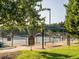 View of the Breckenridge tennis courts, benches, shade, landscaping, and fencing at 122 Button Rd, Morrisville, NC 27560