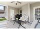 Comfortable back porch seating area with outdoor kitchen and ceiling fan provides relaxation and entertainment at 13 Nettletree Creek Ct, Youngsville, NC 27596