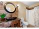 Stylish bathroom with a unique vanity, a round mirror and modern fixtures at 13 Nettletree Creek Ct, Youngsville, NC 27596