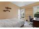 Bedroom featuring neutral paint, a patterned bedspread, and a workspace near the window at 13 Nettletree Creek Ct, Youngsville, NC 27596