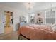 Elegant bedroom featuring hanging swing chair, large bed, and two windows at 13 Nettletree Creek Ct, Youngsville, NC 27596