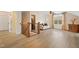 Open bonus room with wood floors, staircase, a white sofa, and a window with curtains at 13 Nettletree Creek Ct, Youngsville, NC 27596