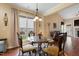 Cozy breakfast nook featuring a glass table, ornate chairs, and hardwood floors with ample natural light at 13 Nettletree Creek Ct, Youngsville, NC 27596