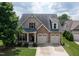 Charming home with a stone and siding facade, a well-manicured lawn, and a two-car garage at 13 Nettletree Creek Ct, Youngsville, NC 27596