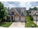 Well-maintained home with stone accents, a two-car garage, and a neatly landscaped front yard at 13 Nettletree Creek Ct, Youngsville, NC 27596
