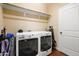 Well lit laundry room with washer, dryer, shelves and a door at 13 Nettletree Creek Ct, Youngsville, NC 27596