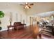 Open-concept living room featuring hardwood floors, tall ceilings, decorative niches, comfortable seating and flowing natural light at 13 Nettletree Creek Ct, Youngsville, NC 27596