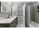 Stylish bathroom features a modern vanity with marble countertop and a hexagon-tiled shower/tub at 13121 Melvin Arnold Rd, Raleigh, NC 27613