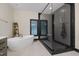 Modern bathroom showcasing a soaking tub, glass-enclosed shower, sleek design, and bright natural light at 13121 Melvin Arnold Rd, Raleigh, NC 27613