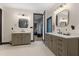 Luxurious bathroom with double vanities, modern fixtures, and access to the bedroom at 13121 Melvin Arnold Rd, Raleigh, NC 27613