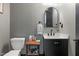 Stylish powder room with textured wallpaper, modern fixtures, and vanity storage at 13121 Melvin Arnold Rd, Raleigh, NC 27613