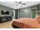 Comfortable bedroom features a king bed, dresser, stylish décor, and backyard views at 13121 Melvin Arnold Rd, Raleigh, NC 27613
