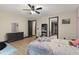 Cozy bedroom with ceiling fan, hardwood floors, and comfortable furnishings at 13121 Melvin Arnold Rd, Raleigh, NC 27613