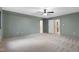 Spacious bedroom with soft carpet, neutral walls, a ceiling fan, and multiple entryways at 13121 Melvin Arnold Rd, Raleigh, NC 27613