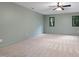 Bright, spacious bonus room with carpet flooring, two windows, and neutral-colored walls at 13121 Melvin Arnold Rd, Raleigh, NC 27613
