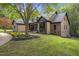 Charming brick home with a well-manicured lawn and mature trees, offering a serene and inviting curb appeal at 13121 Melvin Arnold Rd, Raleigh, NC 27613