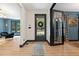 Inviting foyer with a stylish rug, modern lighting, and a glimpse of the living spaces beyond at 13121 Melvin Arnold Rd, Raleigh, NC 27613
