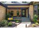 Inviting front porch with comfortable seating and stylish decor, creating a welcoming outdoor space at 13121 Melvin Arnold Rd, Raleigh, NC 27613