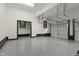 Spacious garage with epoxy flooring, a pedestrian door, and an automated overhead door at 13121 Melvin Arnold Rd, Raleigh, NC 27613