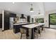 Modern kitchen with black cabinets, stainless steel appliances, and a large center island perfect for cooking at 13121 Melvin Arnold Rd, Raleigh, NC 27613