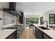 Modern kitchen features quartz countertops, stainless steel appliances, and stylish black and white backsplash at 13121 Melvin Arnold Rd, Raleigh, NC 27613