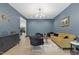 Stylish living room with blue walls, decorative touches, and comfortable seating arrangements at 13121 Melvin Arnold Rd, Raleigh, NC 27613