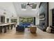Spacious living room features a brick fireplace, skylights, and seamless access to the outdoor living space at 13121 Melvin Arnold Rd, Raleigh, NC 27613