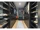 Organized walk-in closet with custom shelving, drawers, and a stylish rug at 13121 Melvin Arnold Rd, Raleigh, NC 27613