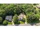 Aerial view of a home nestled among mature trees, showcasing its landscaped yard and driveway at 1420 Heritage Links Dr, Wake Forest, NC 27587