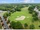 An aerial view of a home near a sprawling golf course under a partly cloudy sky at 1420 Heritage Links Dr, Wake Forest, NC 27587