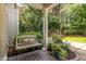Relaxing back porch with a cushioned swing, plants and privacy at 1420 Heritage Links Dr, Wake Forest, NC 27587
