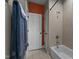 Cozy bathroom showcasing a shower over tub combination and an orange accent wall at 1420 Heritage Links Dr, Wake Forest, NC 27587