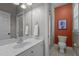 Modern bathroom with a white vanity, large mirror, and access to the toilet at 1420 Heritage Links Dr, Wake Forest, NC 27587