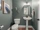 Stylish powder room with a pedestal sink and decorative accents at 1420 Heritage Links Dr, Wake Forest, NC 27587