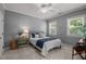 Comfortable bedroom with a queen-sized bed, side table, and two windows at 1420 Heritage Links Dr, Wake Forest, NC 27587