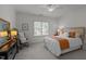 Bright bedroom featuring a queen-size bed, a wooden headboard and a dark vanity at 1420 Heritage Links Dr, Wake Forest, NC 27587