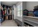 Organized walk-in closet with shelving, hanging rods, and bench seating by window at 1420 Heritage Links Dr, Wake Forest, NC 27587