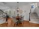 This dining area showcases an elegant chandelier and beautiful hardwood floors at 1420 Heritage Links Dr, Wake Forest, NC 27587