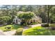 Beautiful two-story home with lush landscaping, mature trees, and a long driveway at 1420 Heritage Links Dr, Wake Forest, NC 27587
