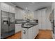 Stylish kitchen with white cabinets, a stainless steel refrigerator, and a central island at 1420 Heritage Links Dr, Wake Forest, NC 27587