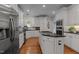 Bright kitchen with white cabinetry, stainless steel appliances, and a center island with a cooktop at 1420 Heritage Links Dr, Wake Forest, NC 27587