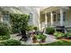 Stone patio with comfortable seating, a grill, and vibrant landscaping, perfect for outdoor relaxation at 1420 Heritage Links Dr, Wake Forest, NC 27587