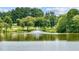 A picturesque pond with a fountain and a golf course in the background at 1420 Heritage Links Dr, Wake Forest, NC 27587