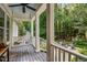 Inviting porch with a swing, comfortable pillows, and views of the surrounding greenery at 1420 Heritage Links Dr, Wake Forest, NC 27587