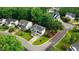 An aerial view of a landscaped corner lot with mature trees and lush green lawns at 1480 Big Leaf Loop, Apex, NC 27502